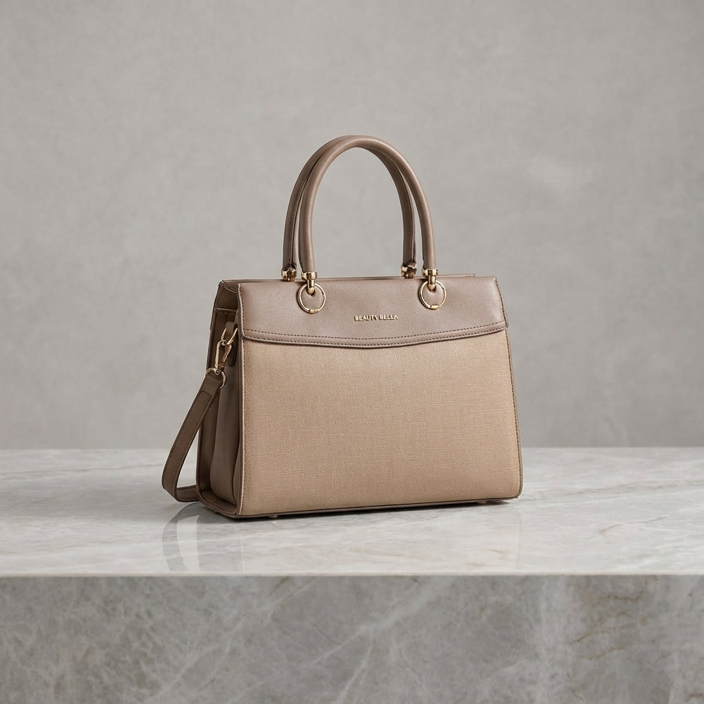A structured beige handbag with a top handle and shoulder strap, displayed on a light marble surface against a textured gray background.
