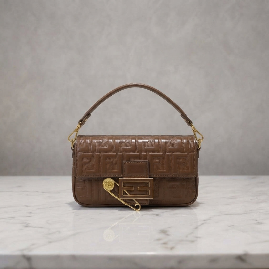 Monogram Embossed Baguette Shoulder Bag with Safety Pin Accent